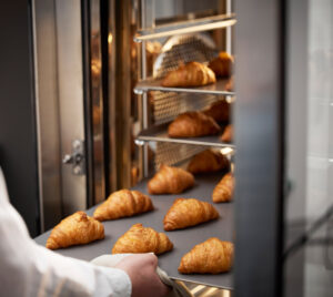 Golden croissants just out of an Invoq oven, highlighting uniform baking and high-quality results